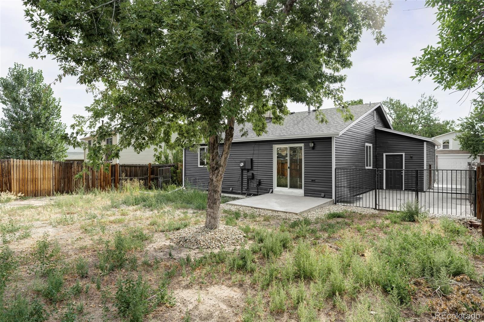 4345 Eagle Street Denver, CO 80239 - Photo 20 of 20 a house with trees in the background