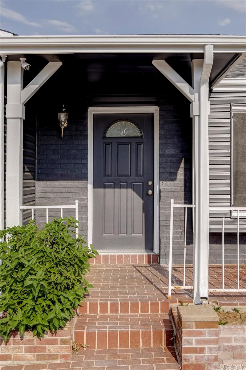 4345 Eagle Street Denver, CO 80239 - Photo 2 of 20 a front view of a house with a garden