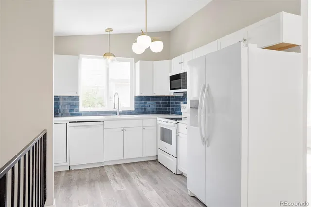 a kitchen with a refrigerator and a sink