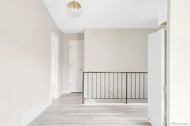 a view of a room with wooden floor