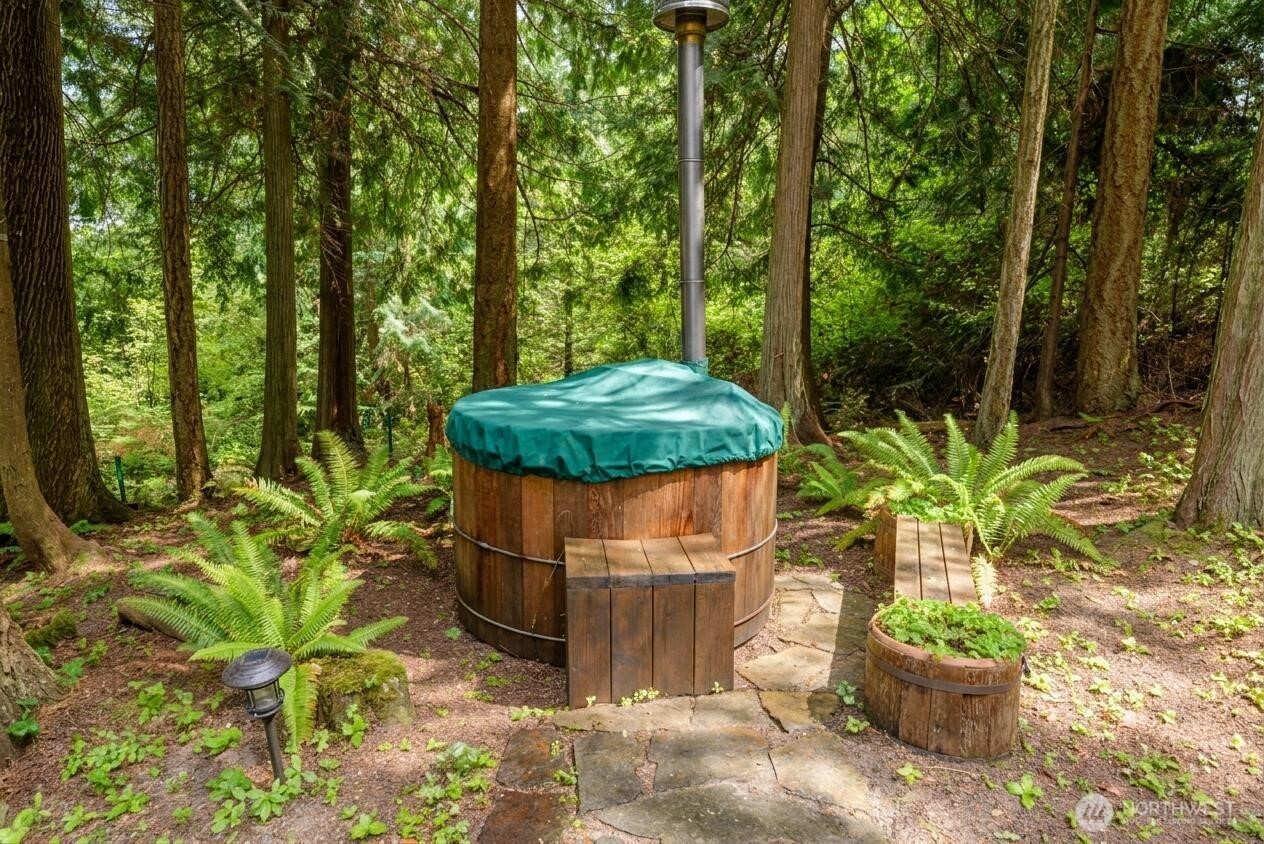 214 Cougar Crest Road Sequim, WA 98382 - Photo 26 of 30 a view of a garden with a fountain