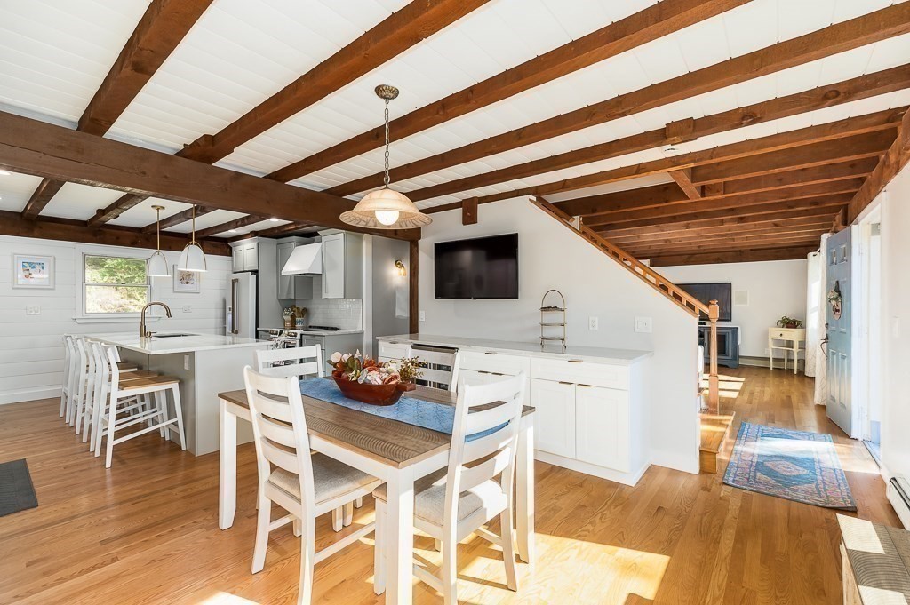 28 Macomber Road Gloucester, MA 01930 - Photo 15 of 40 a kitchen with a table chairs stove and wooden floor