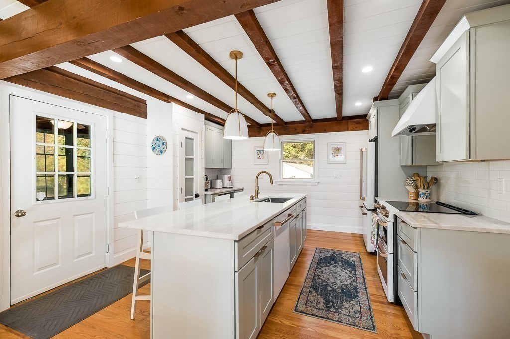 28 Macomber Road Gloucester, MA 01930 - Photo 18 of 40 a kitchen with a sink stove and cabinets