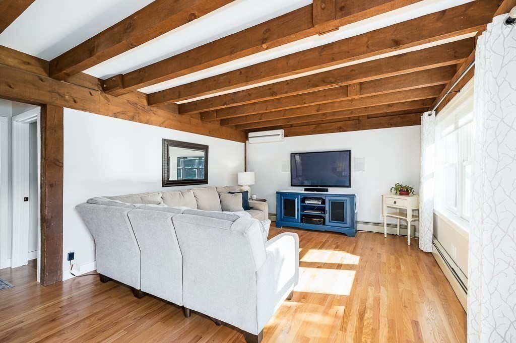 28 Macomber Road Gloucester, MA 01930 - Photo 22 of 40 a living room with furniture and a flat screen tv