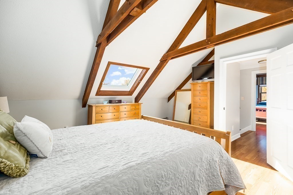 28 Macomber Road Gloucester, MA 01930 - Photo 30 of 40 a bedroom with a large bed and a large window