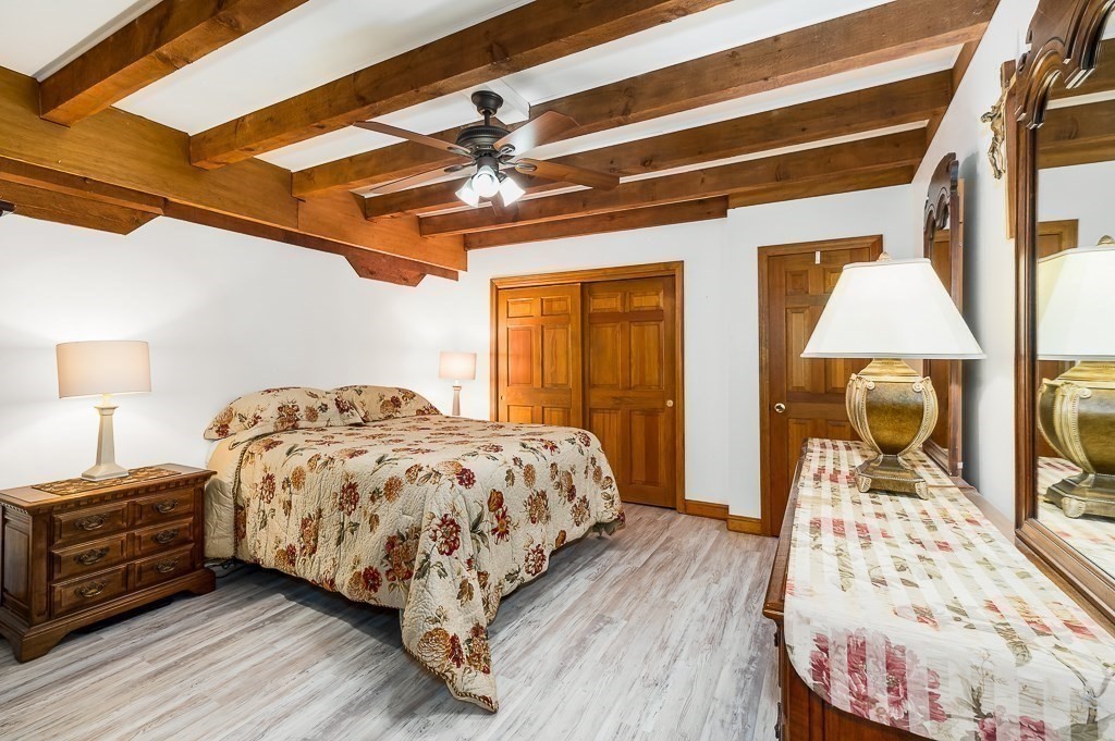 28 Macomber Road Gloucester, MA 01930 - Photo 32 of 40 a bedroom with a bed and wooden floor