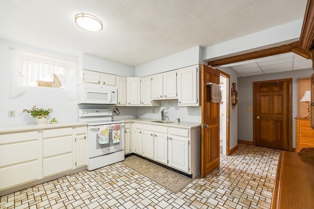 28 Macomber Road Gloucester, MA 01930 - Photo 33 of 40 a kitchen with sink and cabinets