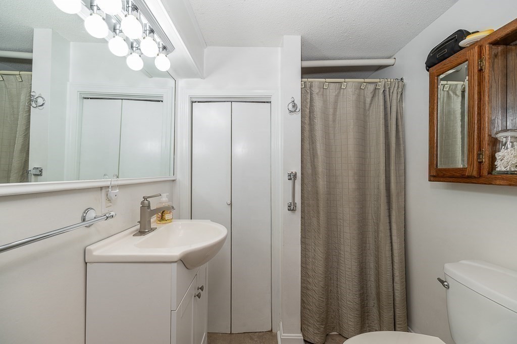 28 Macomber Road Gloucester, MA 01930 - Photo 36 of 40 a bathroom with a sink vanity mirror and toilet