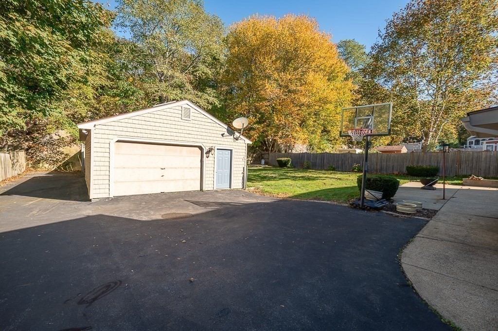 28 Macomber Road Gloucester, MA 01930 - Photo 8 of 40 a front view of a house with a yard and garage