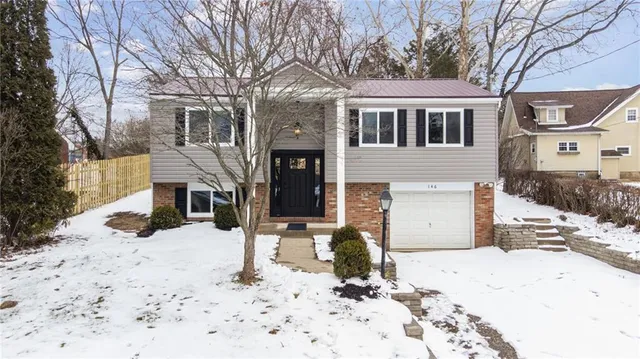 a view of a house with snow on the road