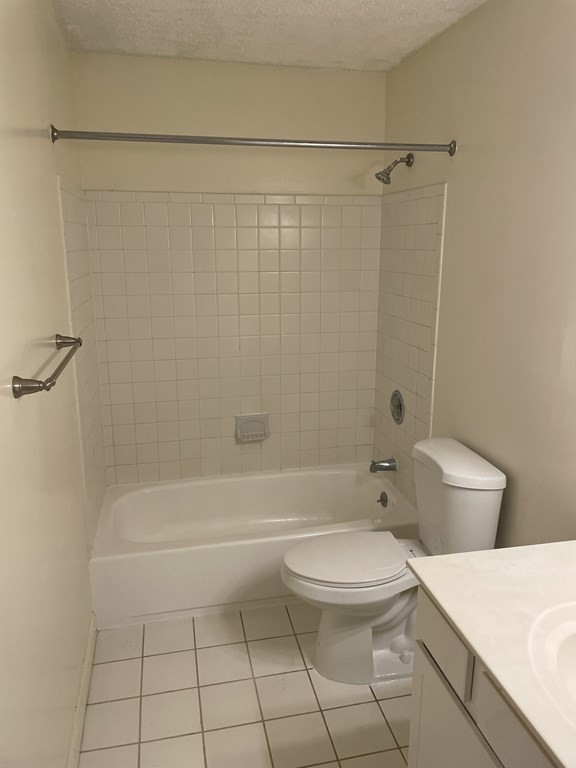 9 Village Way, Unit 17 Natick, MA 01760 - Photo 2 of 5 a bathroom with a toilet and a shower