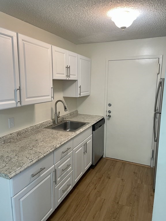 9 Village Way, Unit 17 Natick, MA 01760 - Photo 3 of 5 a kitchen with sink and cabinets