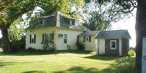 8372 Manchester Road Capron, IL 61012 - Photo 2 of 6 a view of a yard in front of a house with large windows