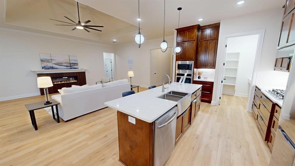 2509 Windmill Lane Longview, TX 75601 - Photo 35 of 35 Kitchen with stainless steel appliances, open floor plan, light wood finished floors, a ceiling fan, and recessed lighting