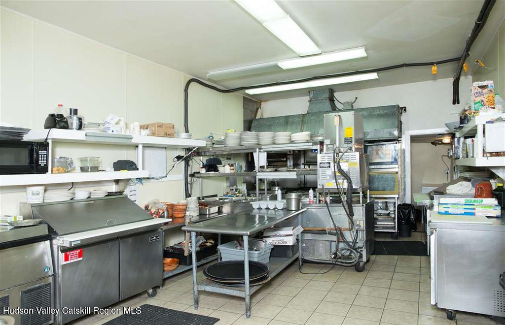 7 Main Street Catskill, NY 12414 - Photo 19 of 29 a kitchen with stainless steel appliances kitchen island granite countertop a sink and cabinets