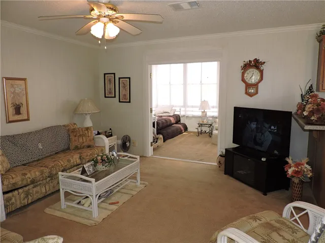 a living room with furniture a fireplace and a window
