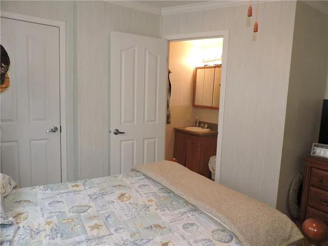 a bedroom with a bed and a mirror