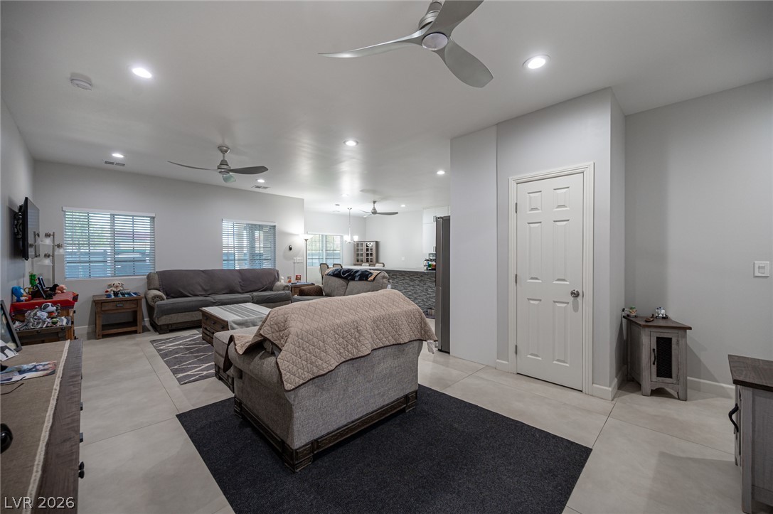 441 Belville Road Pahrump, NV 89048 - Photo 5 of 44 Recessed lighting illuminates this inviting living area, complemented by sleek ceiling fans for optimal comfort.