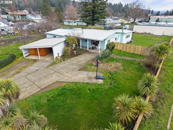a view of a house with a yard and sitting area