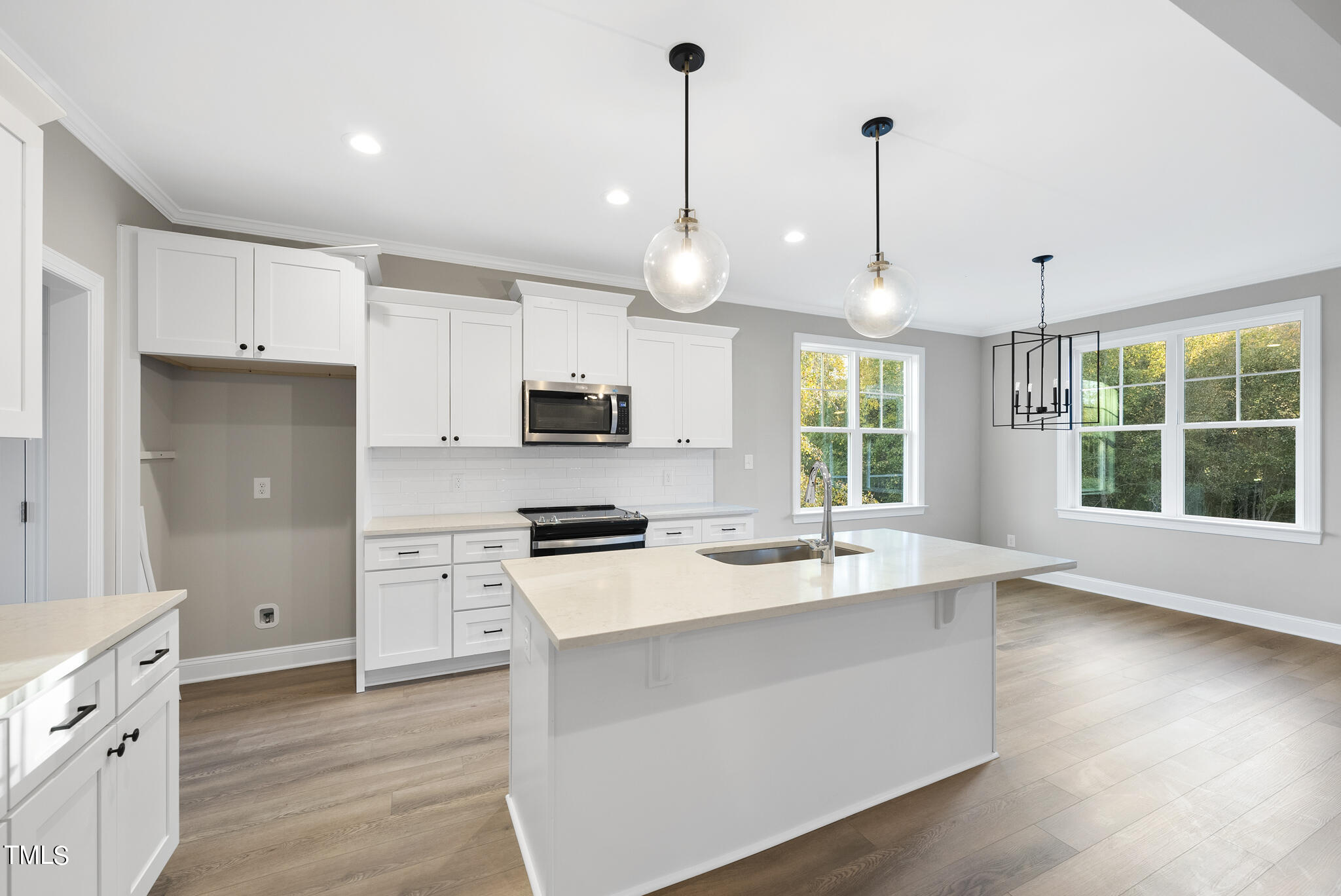 70 Pilot Ridge Road Zebulon, NC 27597 - Photo 11 of 37 a kitchen with stainless steel appliances kitchen island granite countertop a stove a sink a center island a refrigerator and a wooden floor