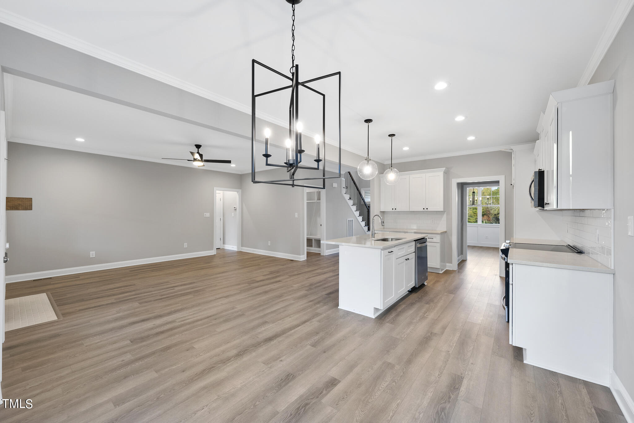 70 Pilot Ridge Road Zebulon, NC 27597 - Photo 15 of 37 a kitchen with kitchen island appliances and wooden floor