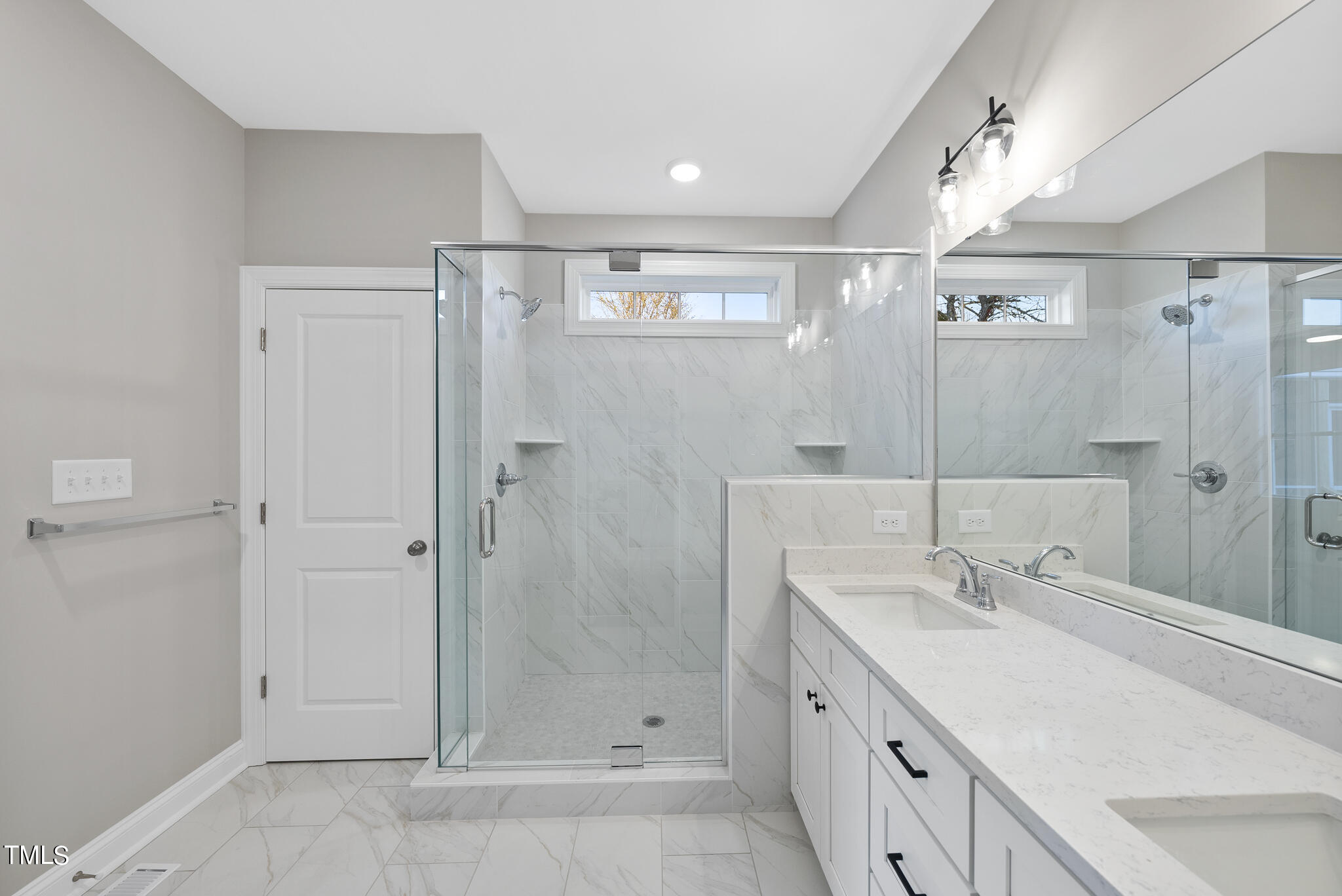 70 Pilot Ridge Road Zebulon, NC 27597 - Photo 27 of 37 a bathroom with a double vanity sink shower and a mirror