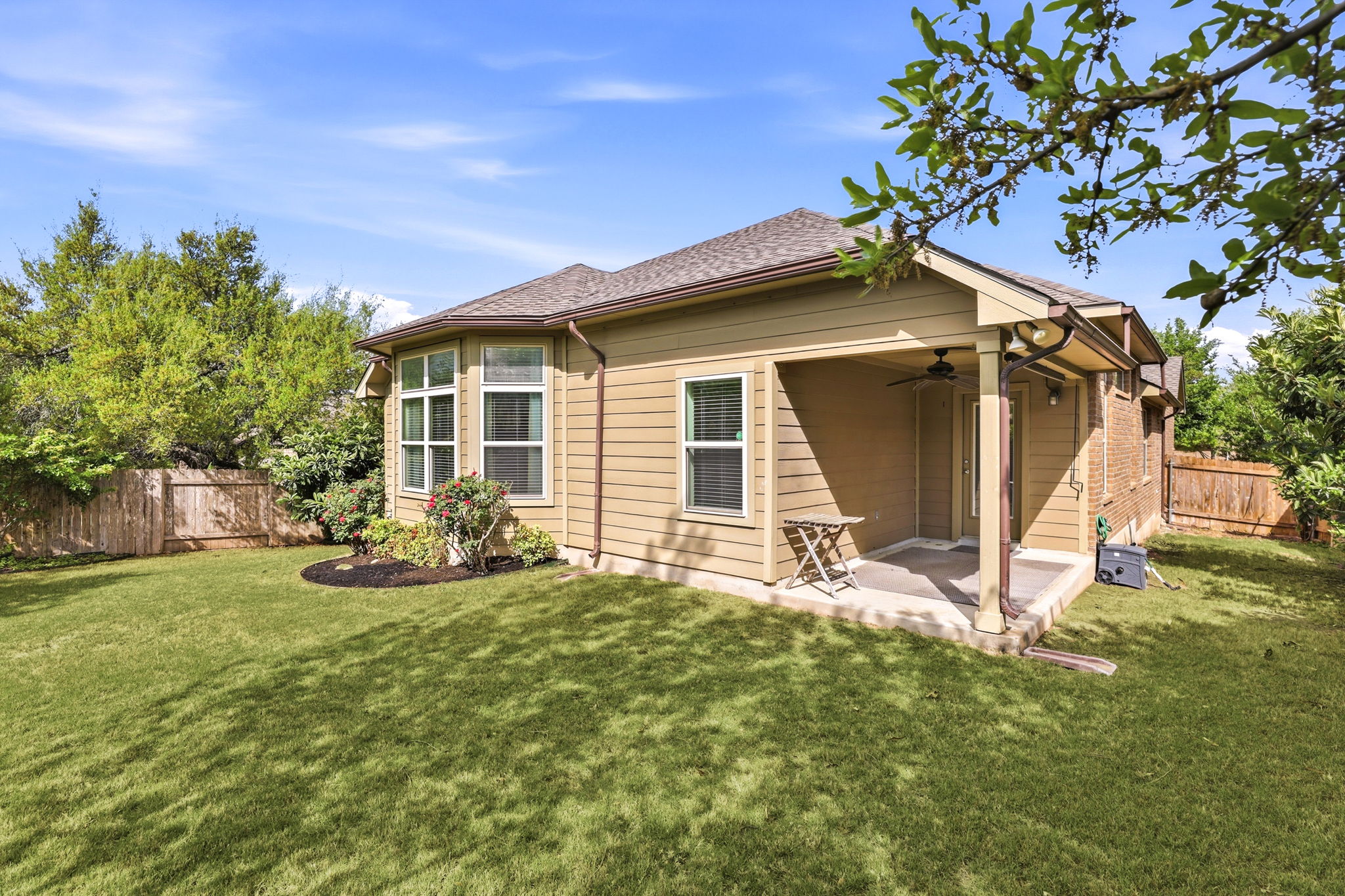 152 Stone View Trail Austin, TX 78737 - Photo 31 of 33 Rear view of house with a fenced backyard, a patio, a ceiling fan, and roof with shingles