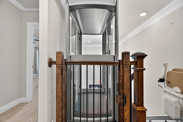 a view of a hallway with wooden floor and staircase