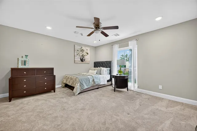 a spacious bedroom with a bed and window