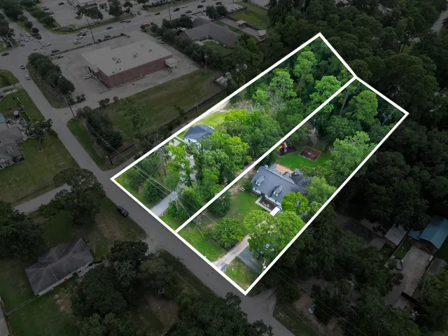 a front view of a house with a yard and green space