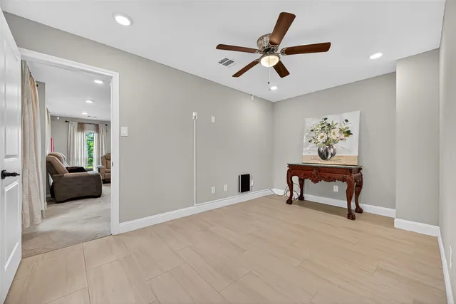 a view of a livingroom with a couch and a ceiling fan