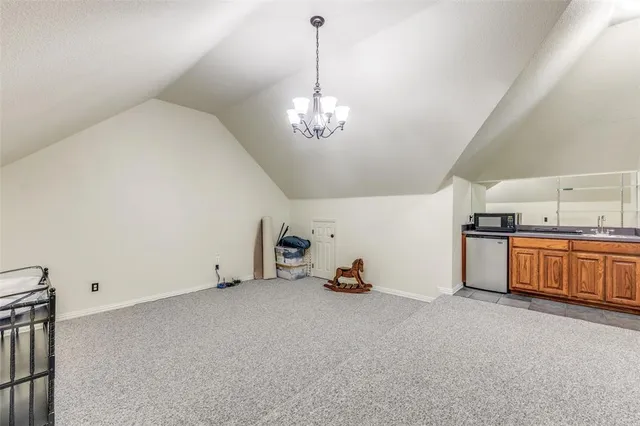 a view of a kitchen with a sink cabinets and a chandelier