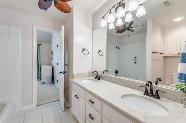 a bathroom with a double vanity sink mirror and shower