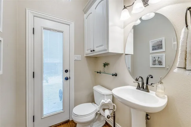 a bathroom with a sink a toilet and a mirror