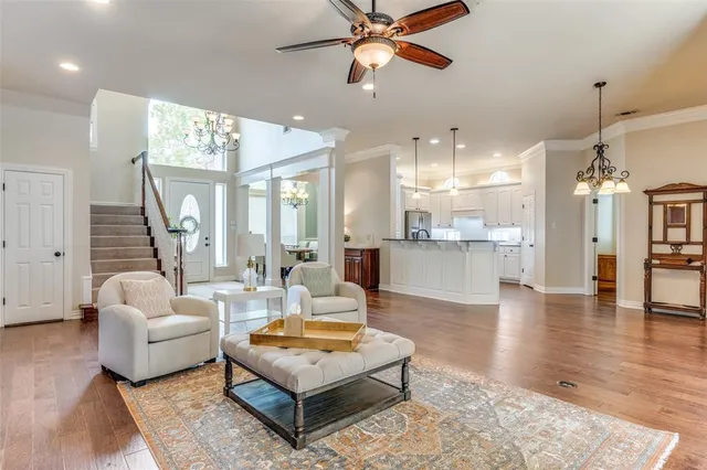a living room with furniture and a chandelier
