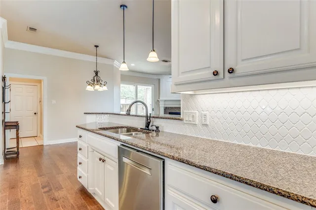 a kitchen with stainless steel appliances granite countertop a sink a counter space and cabinets