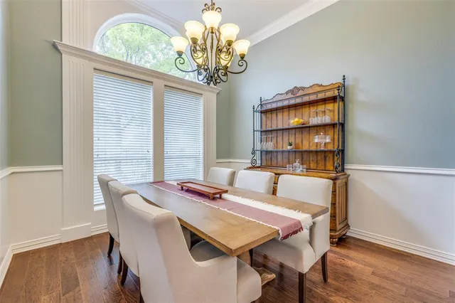 a view of a dining room with furniture wooden floor and chandelier