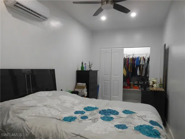 a bedroom with a bed and a large mirror