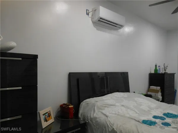 a bedroom with a bed and a potted plant