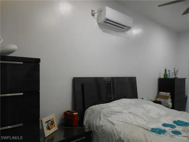 a bedroom with a bed and a potted plant