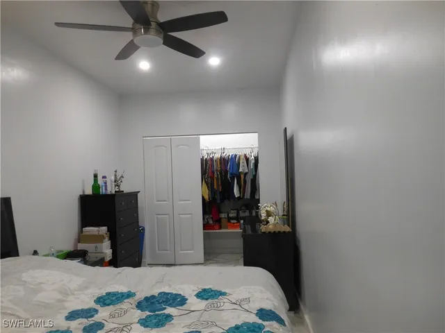 a bedroom with a bed and a mirror