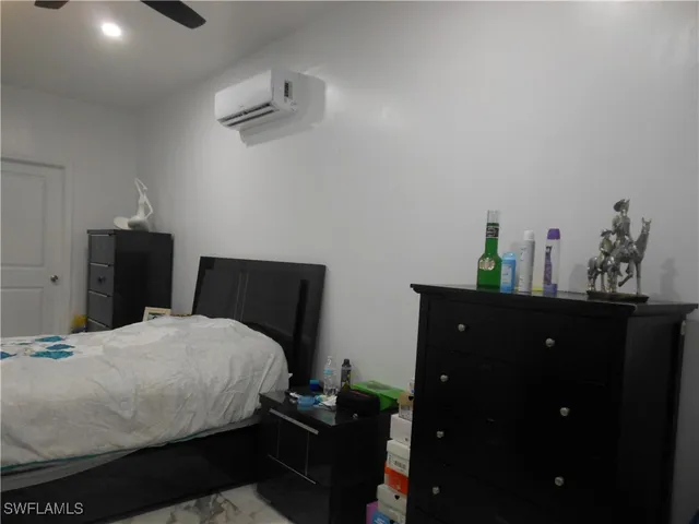 a bedroom with a bed and a dresser