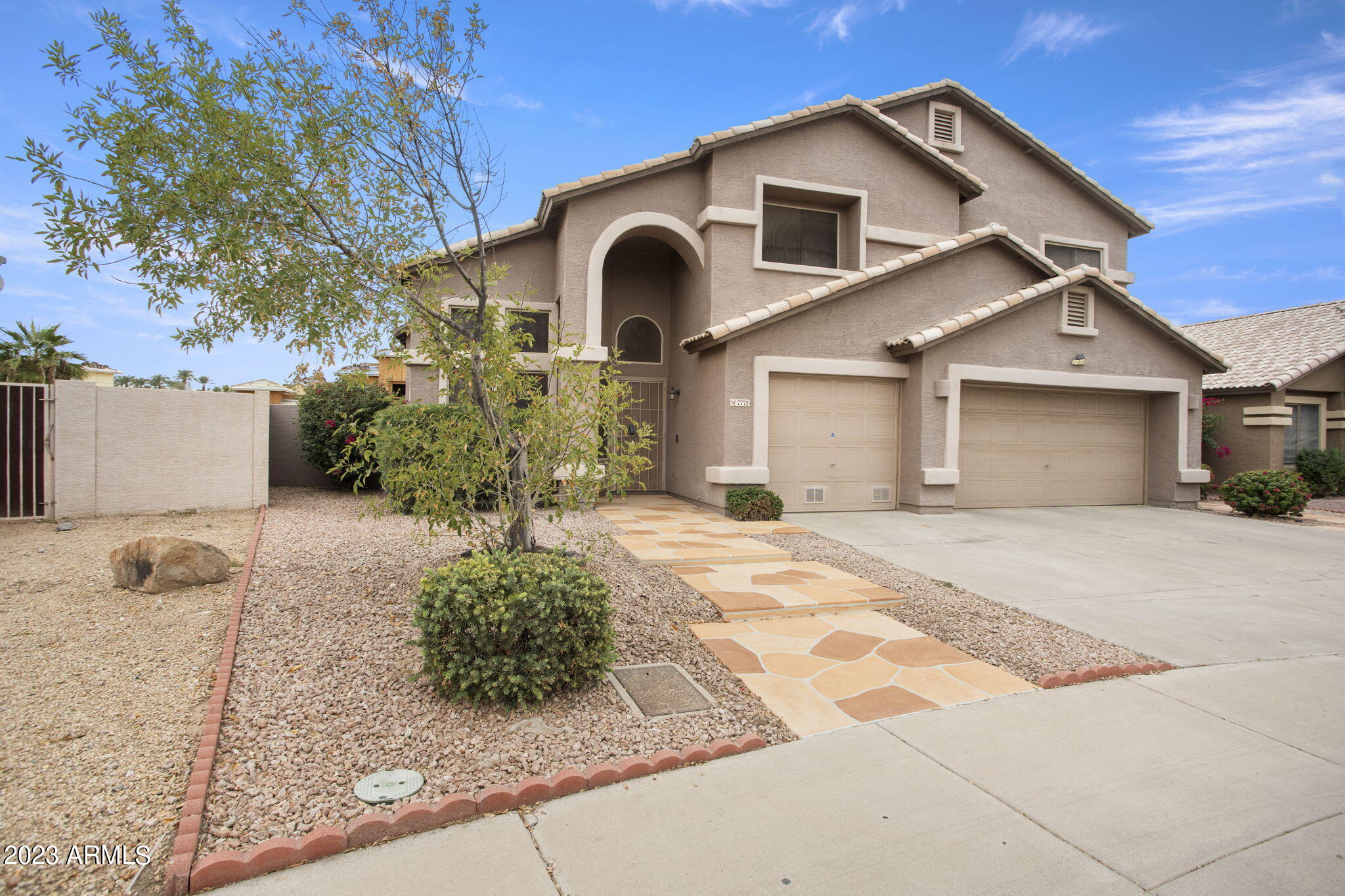 7775 North 52nd Drive Glendale, AZ 85301 - Photo 2 of 51 a front view of a house with garden