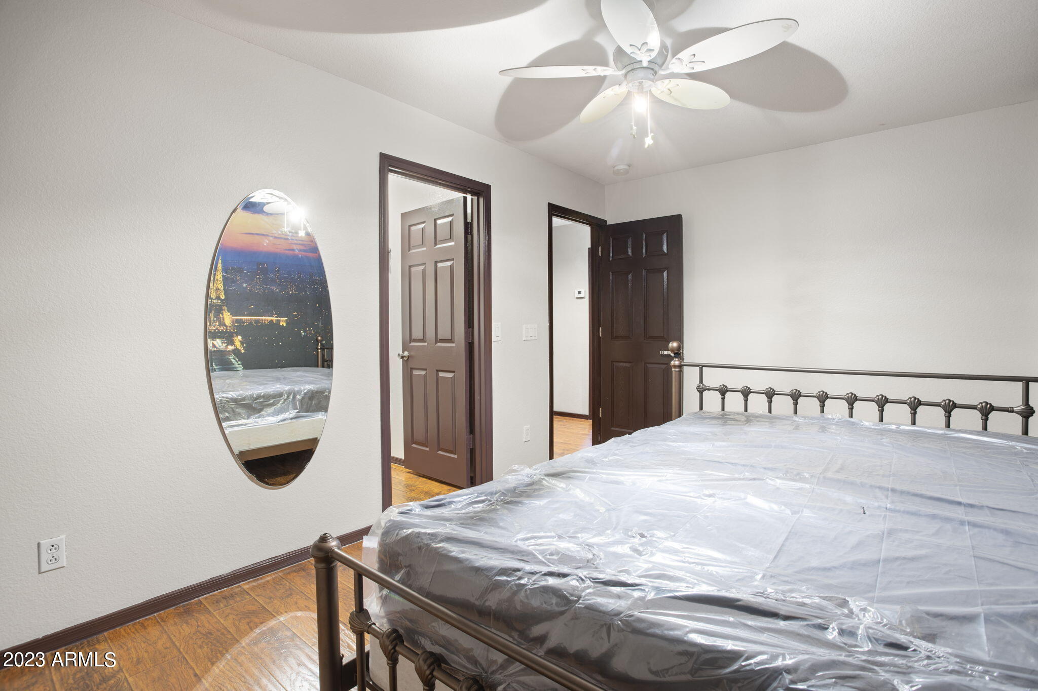 7775 North 52nd Drive Glendale, AZ 85301 - Photo 32 of 51 a bedroom with a bed and a chandelier