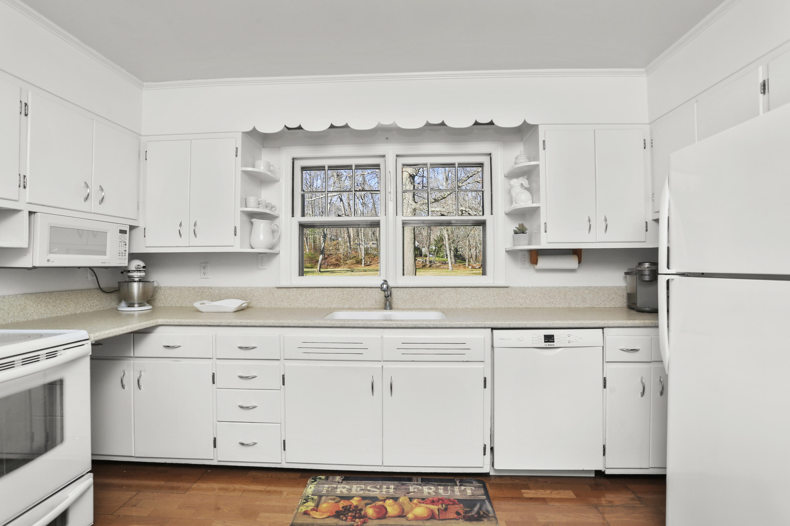 10 Stephen Mather Road Norwalk, CT 06850 - Photo 14 of 29 a kitchen with granite countertop white cabinets and white appliances