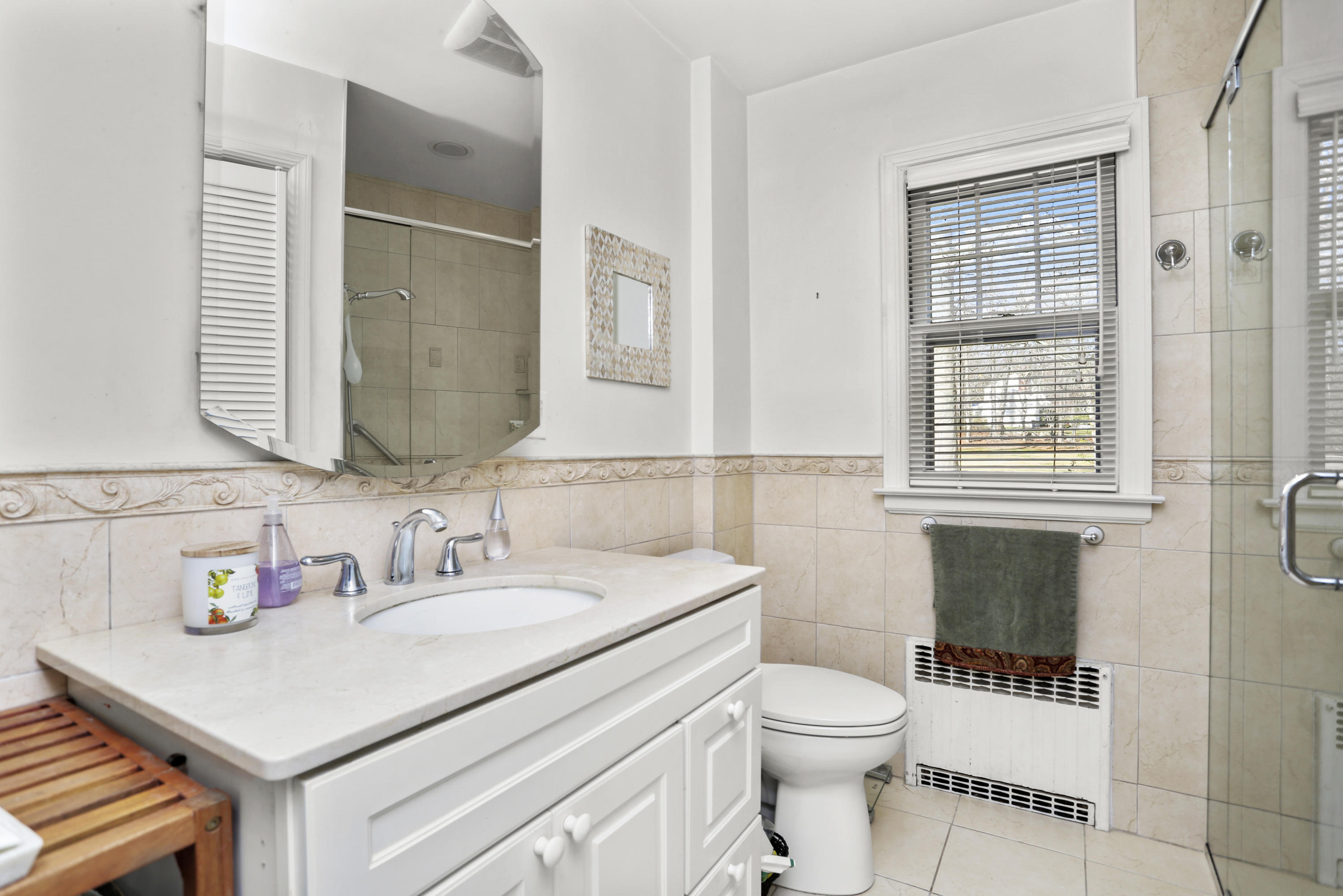 10 Stephen Mather Road Norwalk, CT 06850 - Photo 18 of 29 a bathroom with a sink a toilet and a mirror