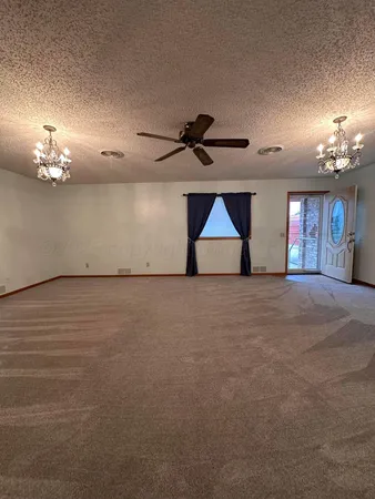 a view of empty room with a ceiling fan