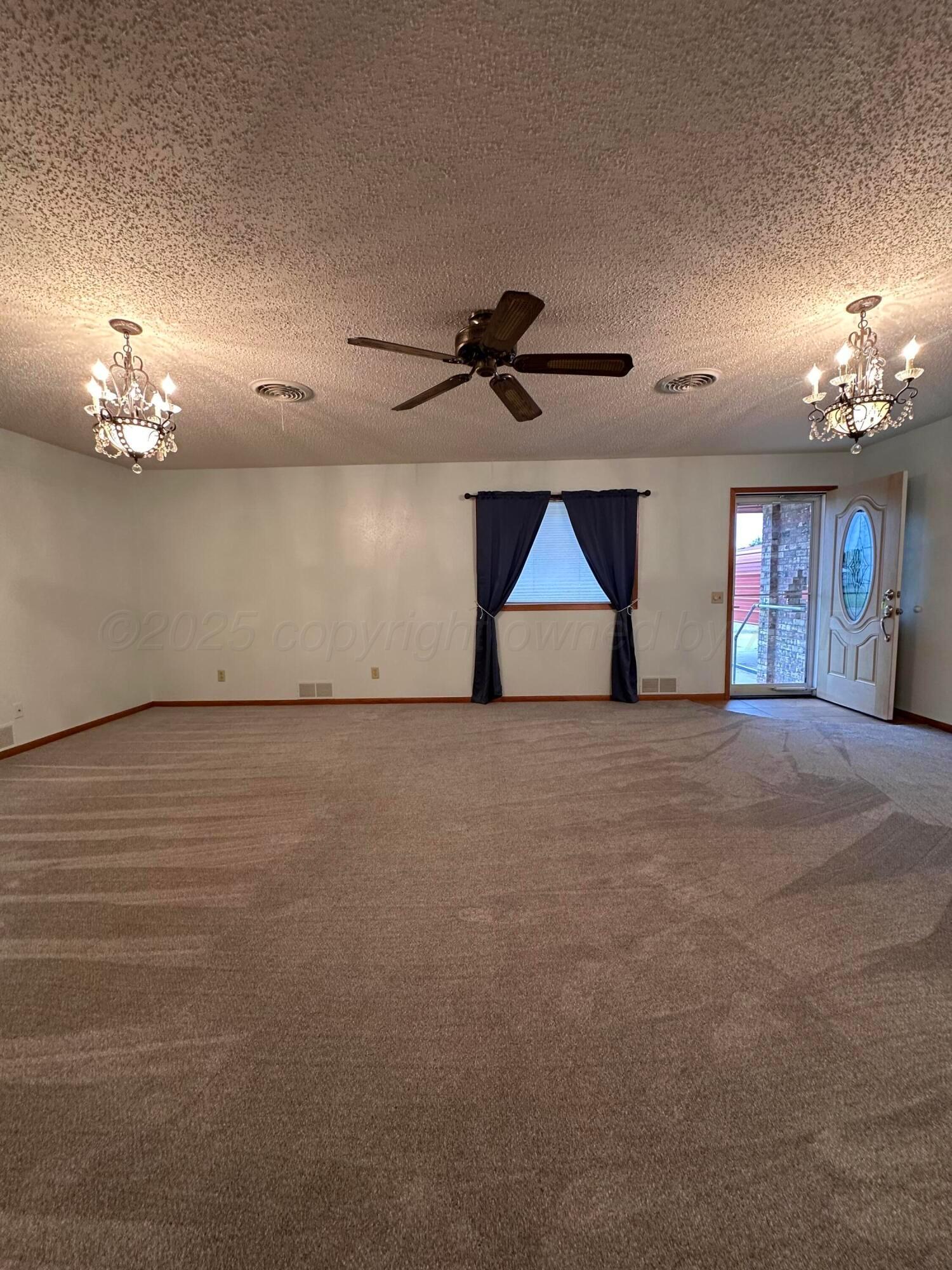 1007 Archer Street Spearman, TX 79081 - Photo 2 of 20 a view of empty room with a ceiling fan