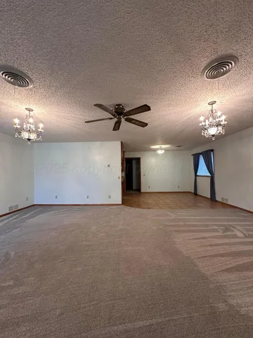 a view of a livingroom with a chandelier fan