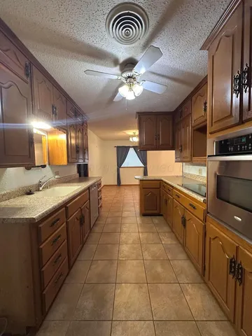 a stove top oven sitting inside of a kitchen